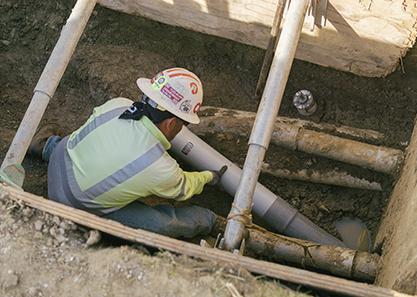 Service tech laying pipes